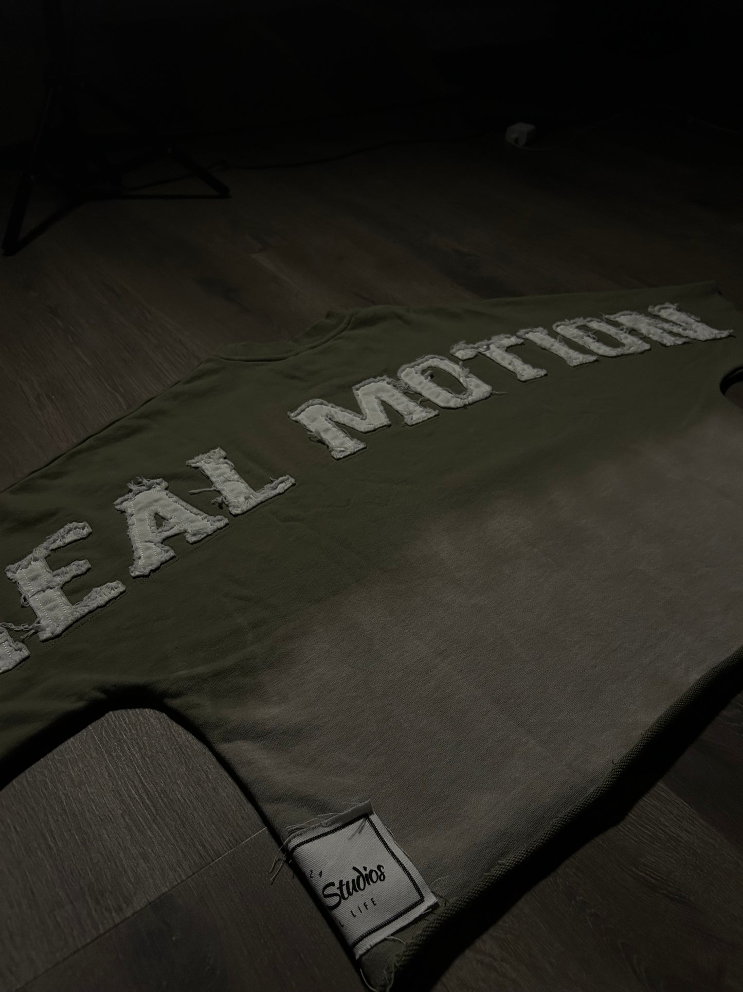 OLIVE GREEN “REAL MOTION” CROP TEE