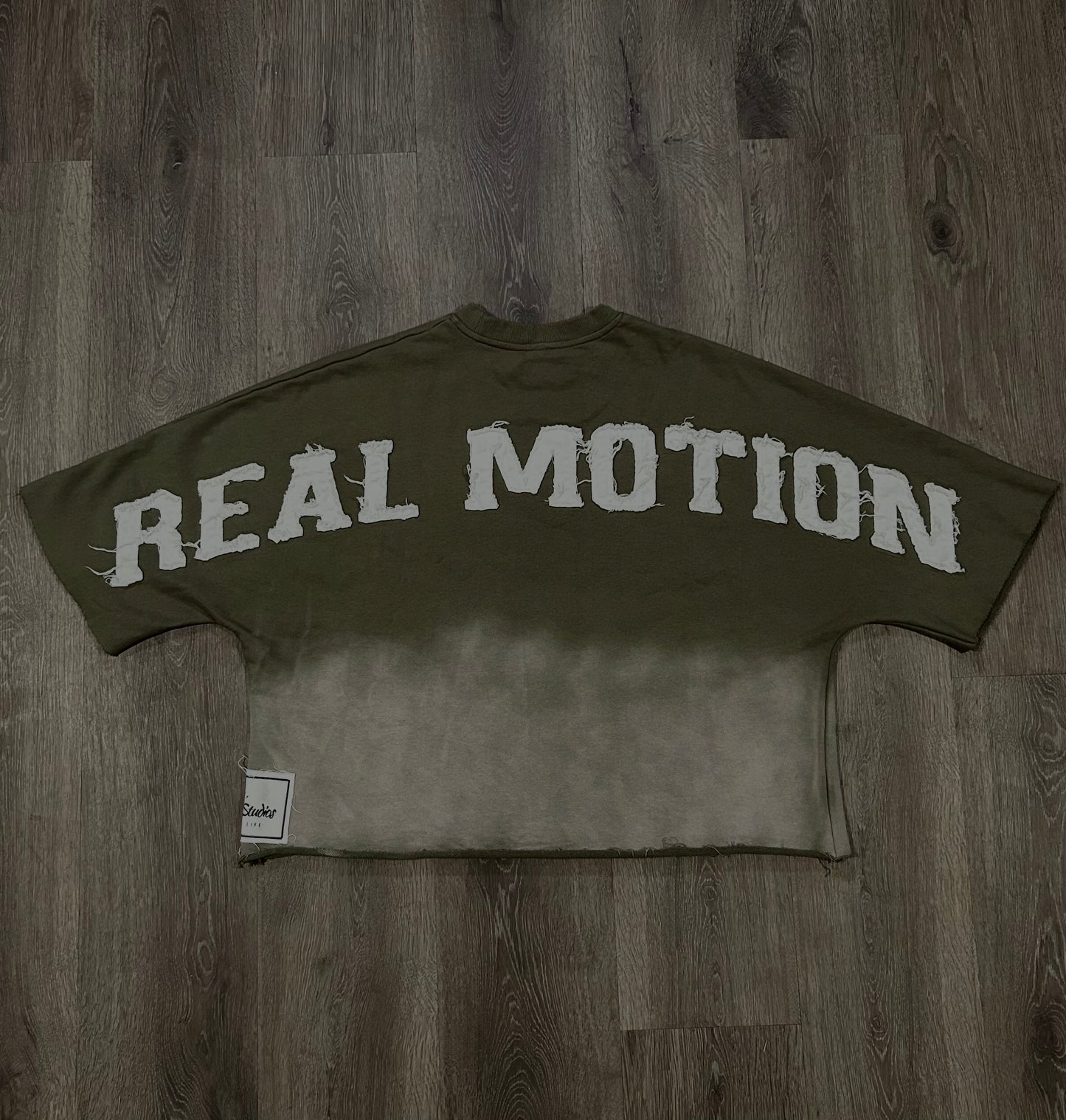 OLIVE GREEN “REAL MOTION” CROP TEE